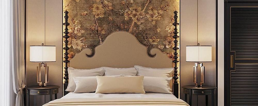 Front view of a well-made bed with cushions, a ceiling fan, and two bedside tables with lamps at The Evren, Vagator.
