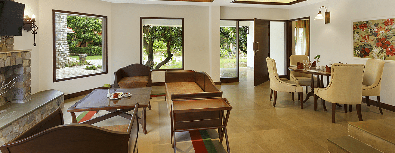 An image of a living area with sofa set and dining area on the other side. There is also a flat TV screen on the wall - The Riverview Retreat, Corbett