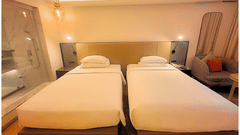 Luxurious Twin Room with Plush Bedding and Modern Furniture