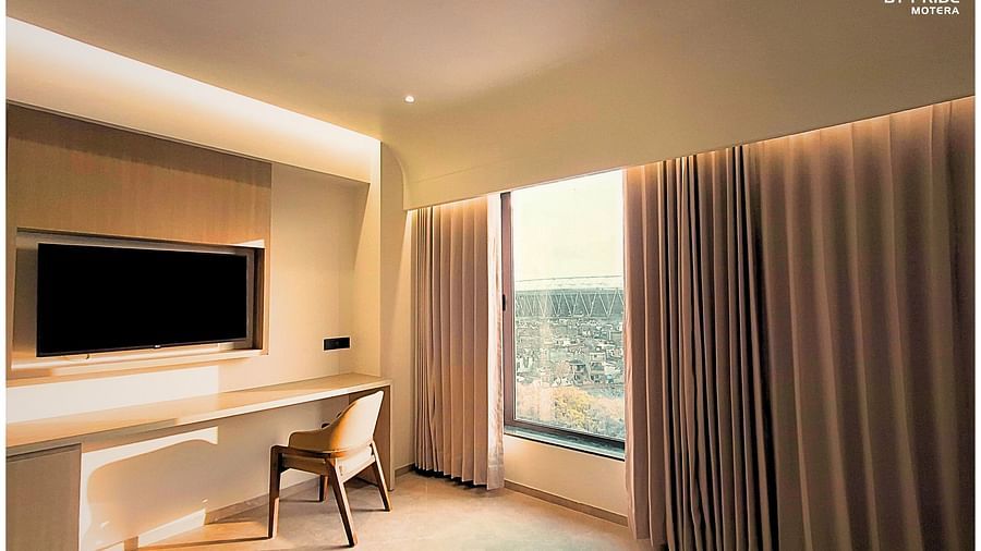 image of a room at biznotel by pride, motera showcasing the huge windows along with a work desk an a wall mounted television