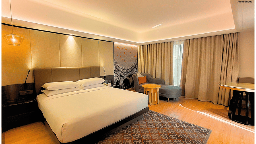 Superior King Room at Pride Plaza Ahmedabad featuring a comfortable king size bed, elegant headboard, bedside lighting, modern décor and thoughtfully arranged interiors for restful comfort.