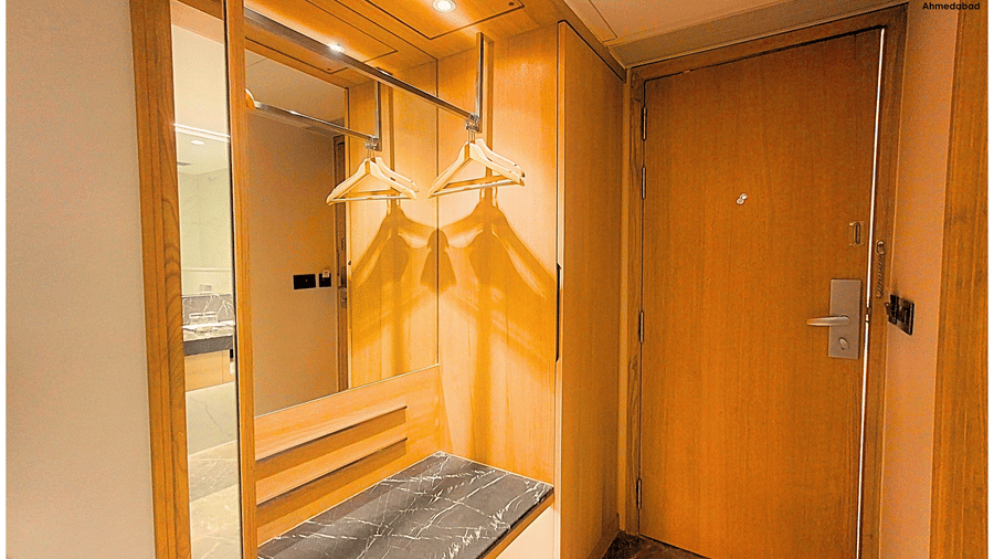 Superior King Room at Pride Plaza Ahmedabad featuring a dedicated wardrobe area with wooden finishes, luggage space, hanging facility and organised storage designed for a comfortable extended stay.