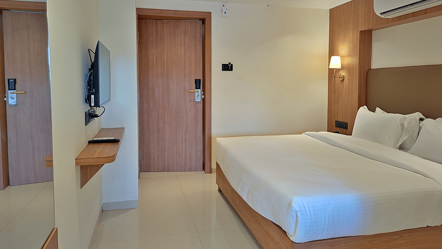 Bedroom with a double bed, wooden furnishings, wardrobe, and doorway