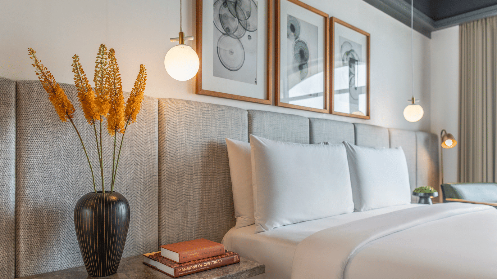 Bedroom with bed, framed artwork, and bedside lamp at The Raintree, St. Mary’s Road.