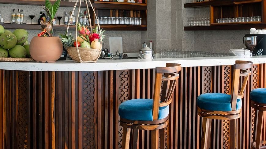 An image of countertop table and chairs placed around it  - Alibu Resort Nha Thrang