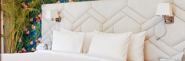 A bedroom with a double bed, side tables and lamps inside terrace suite - Karma Lakelands.