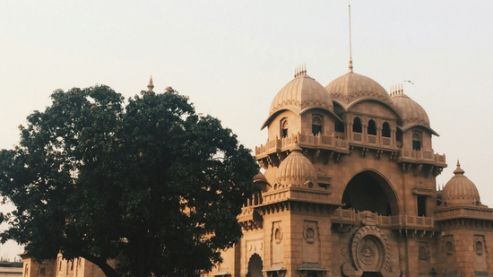 Historic temple structure with intricate architecture and surrounding trees.