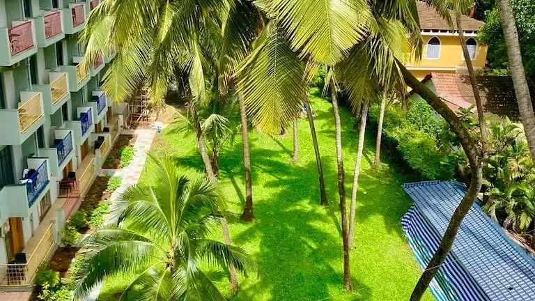 Aerial view of a lawn on a sunny day at Indie Stays Resort, Goa.
