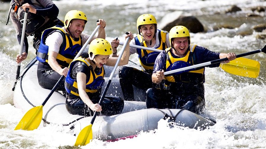 a group of people white water rafting