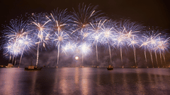 Fireworks being burst over a waterbody at night