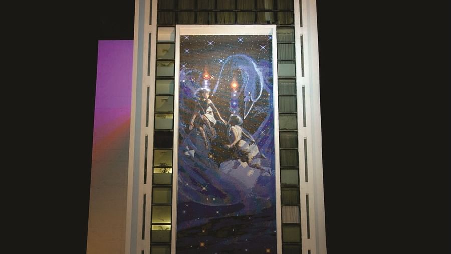 Facade of a night-time view of a modern hotel building illuminated with lights in the ground floor | Gemini Continental