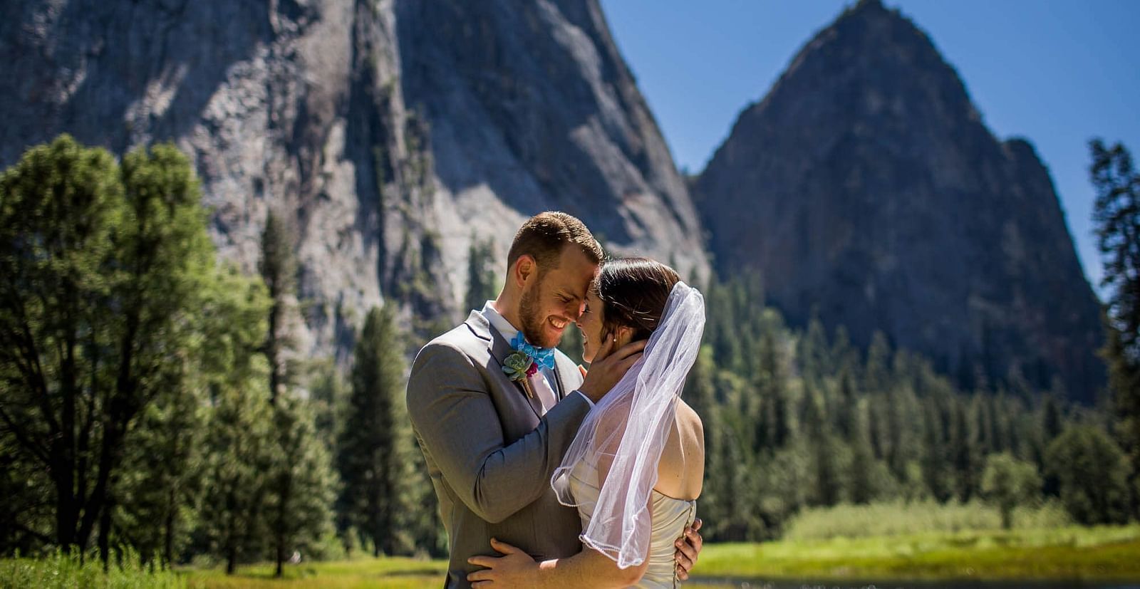 A couple posing for a photoshoot with the Yosemite in the backdrop - Narrow Gauge Inn - A Serenite Hotel Near Fish Camp.