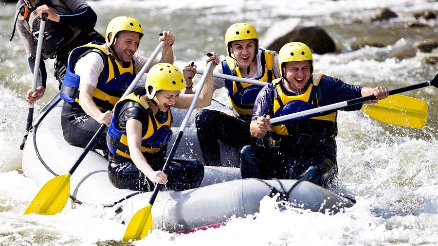 a group of people white water rafting