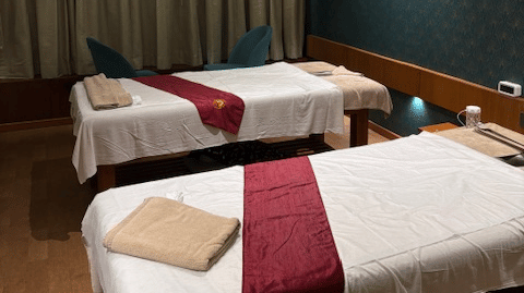 A spacious spa suite featuring 2 side-by-side massage tables with premium bedding - Praveg's Grand Eulogia, Ahmedabad