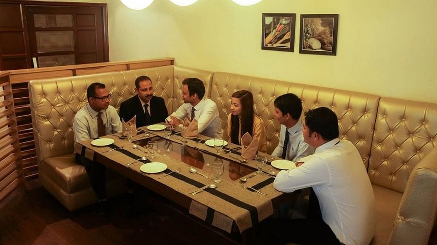 a group of people talking and dining at Ginger