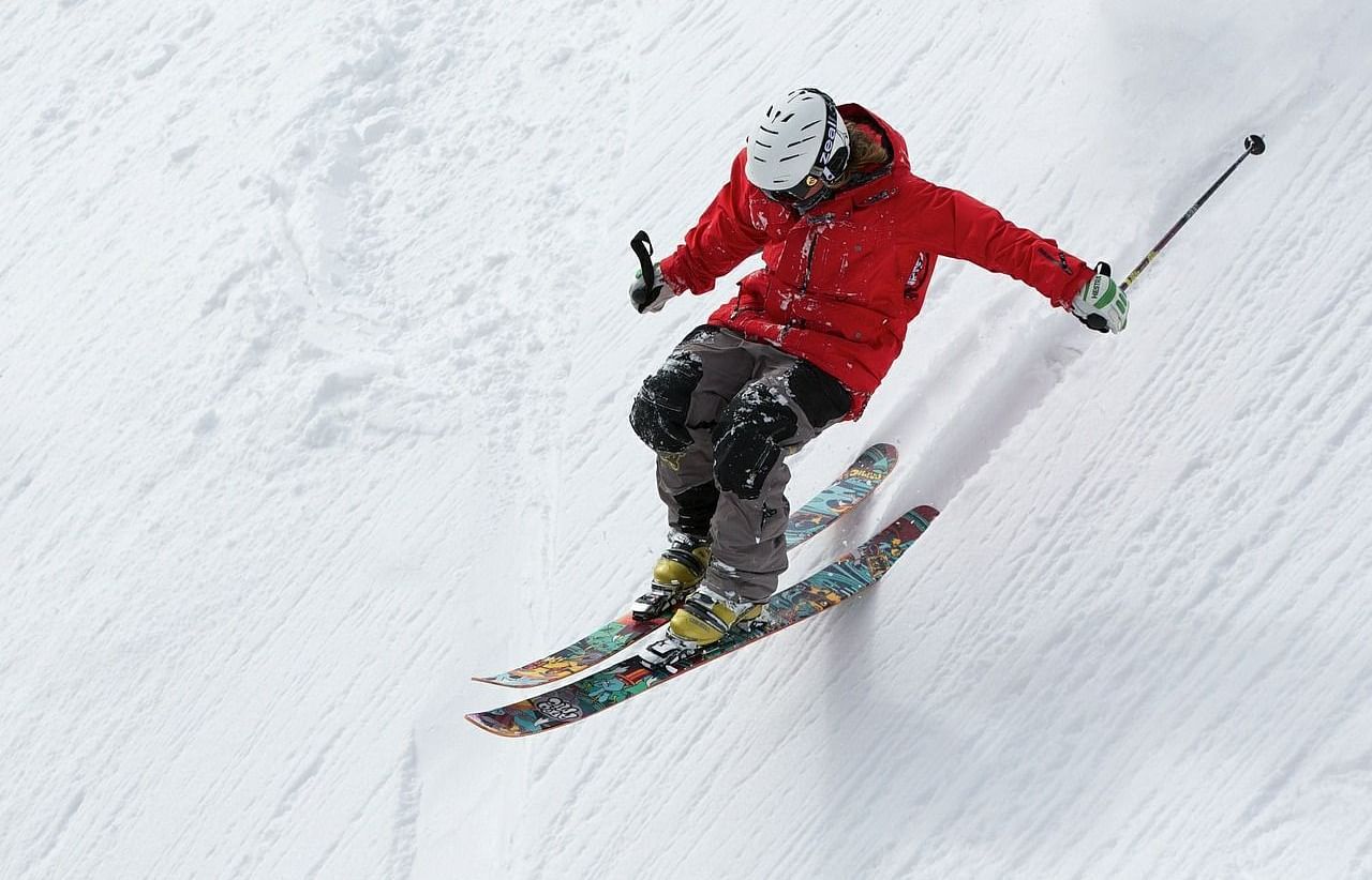 Picture of a person skiing down a snowy slope .