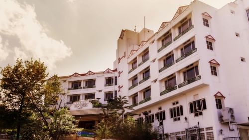 the exterior facade with white clouds in the background - Polo Towers hotel in Shillong