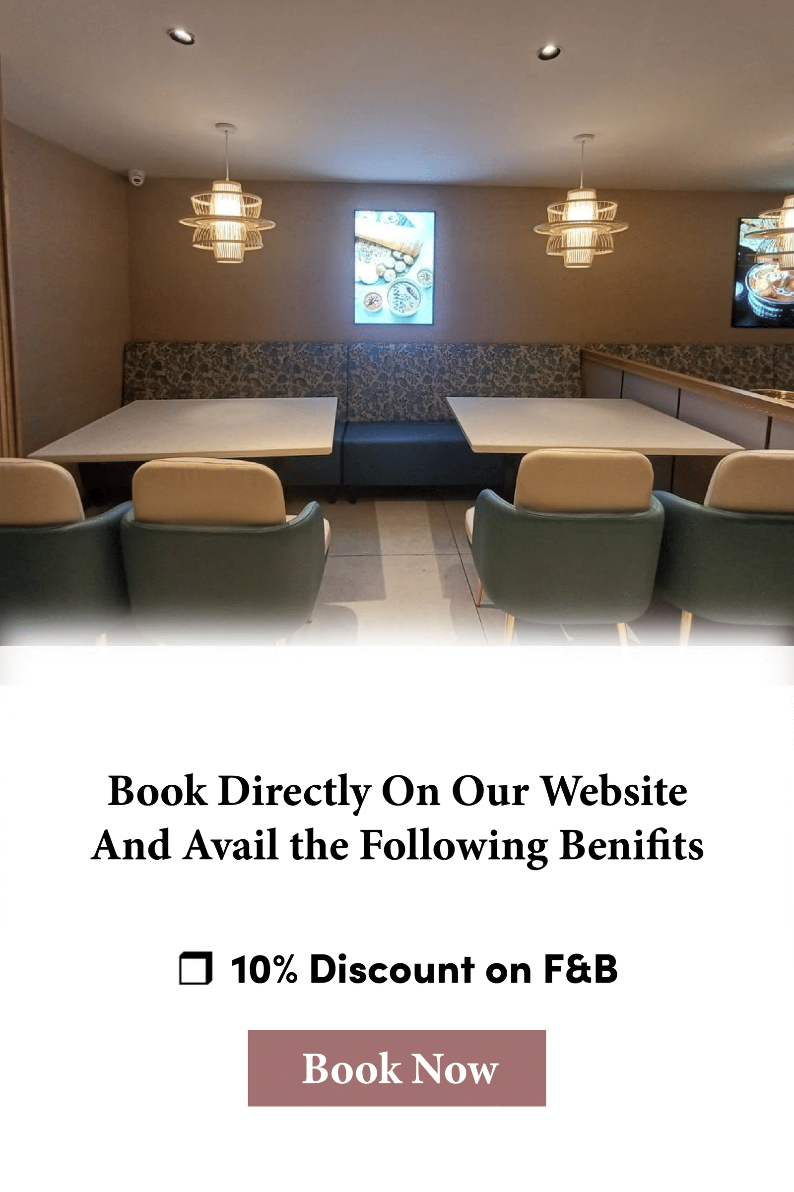 A restaurant at Hotel Raai, Hosur featuring sets of tables and chairs, lights hanging from the ceiling and a digital frames hanged on the wall. The creative also advertises 10 percent discount on Food and Beverages.