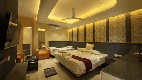 Deluxe Classic Triple Bed Varanda Room with a large bed, wall-mounted TV at Hotel Seagull Digha