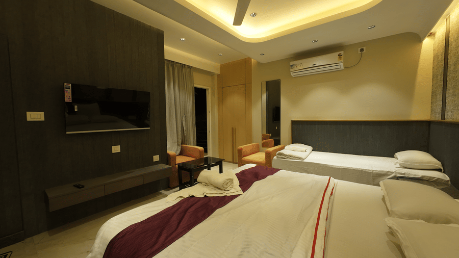 Deluxe Classic Triple Bed Varanda Room with a large bed, wall-mounted TV at Hotel Seagull Digha