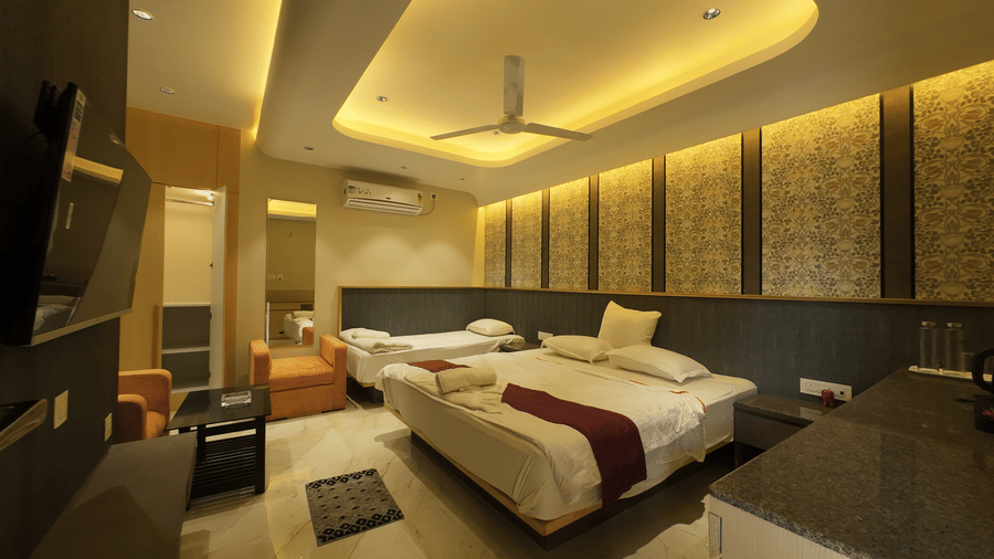 Deluxe Classic Triple Bed Varanda Room with a large bed, wall-mounted TV at Hotel Seagull Digha