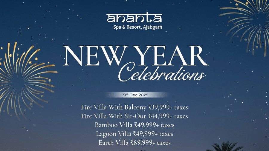 A creative of Ananta Spa & Resort, Ajabgarh, showcasing a row of illuminated, modern Bamboo and Earth villas nestled in lush greenery at night, with fireworks bursting over the dark hills above for the New Year 2025 celebration.