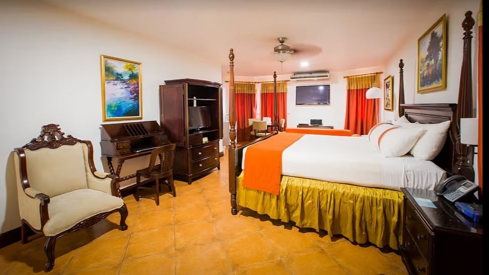 tiled bathroom shows a bathtub, a vanity with two sinks, and a walk-in shower | Alexander Suite | Altamont Court, Jamaica