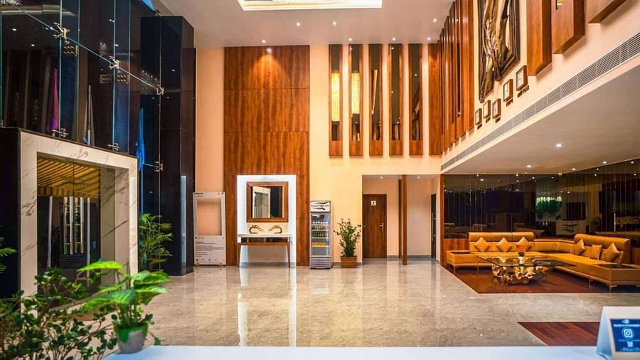 The spacious and modern lobby of Mansha Palace features elegant wooden accents and comfortable seating areas.
