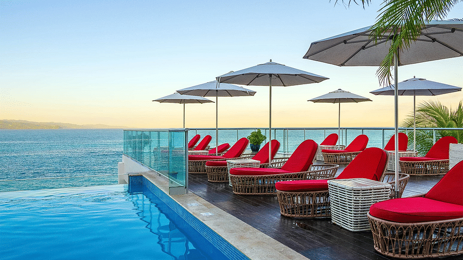 A rooftop pool known as Sky Lounge at our hotel seen during a sunset - S Hotels, Jamaica