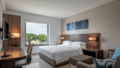 Standard king room featuring a bed, couch, television and a working area at The Residency Towers Rameswaram