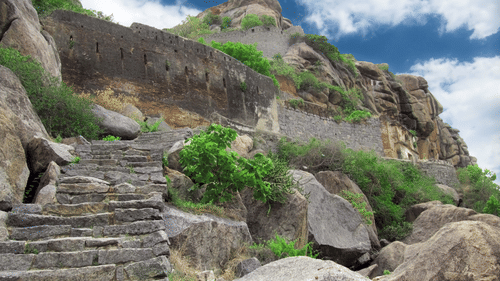 stairs carved out on rocks leading to the top of the mountain