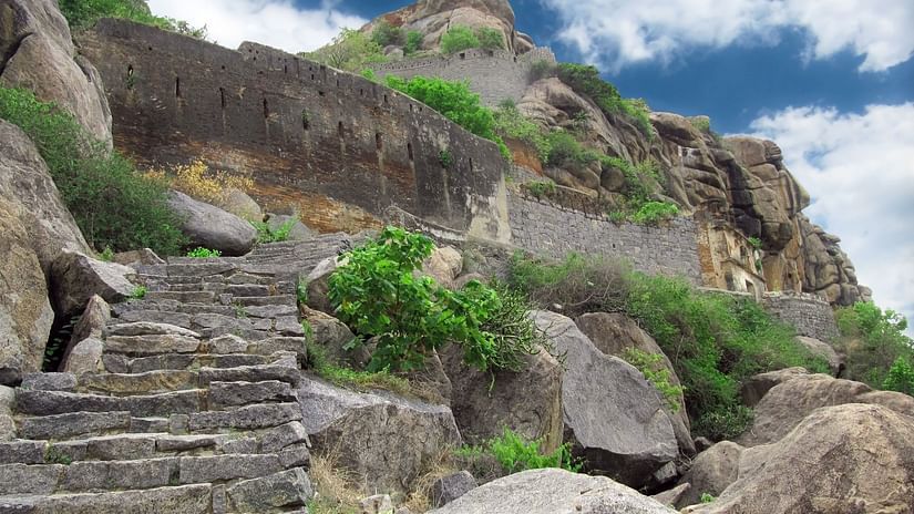 stairs carved out on rocks leading to the top of the mountain