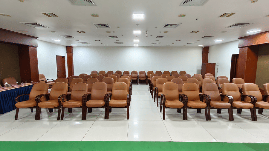 A wide view of a seminar room with rows of cushioned chairs facing a stage at DSF Grand Plaza, Tuticorin.