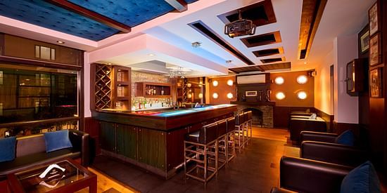 Renest Hotel Manali - Interior view of the bar featuring numerous seating options