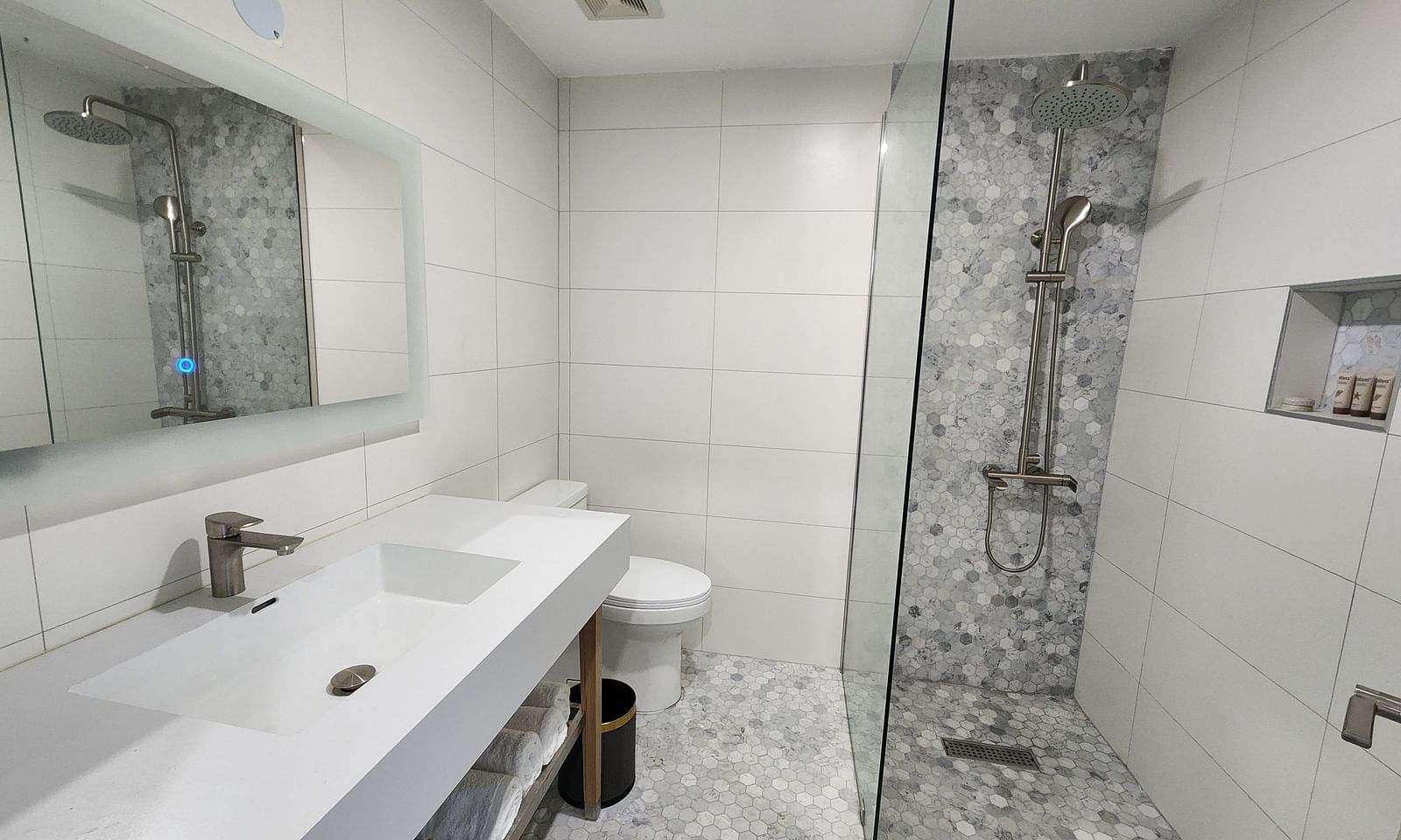 A modern bathroom with sleek white fittings and a glass shower partition - Hotel 39, Jamaica