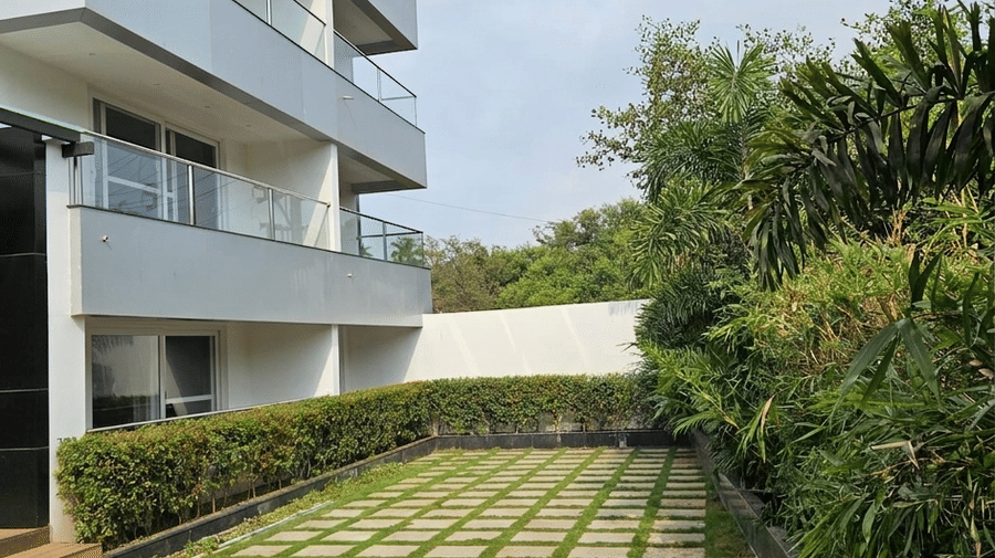 Backyard showing a small section of a pool and a courtyard garden at BluSalzz Collection - Casa Onze, Arpora.