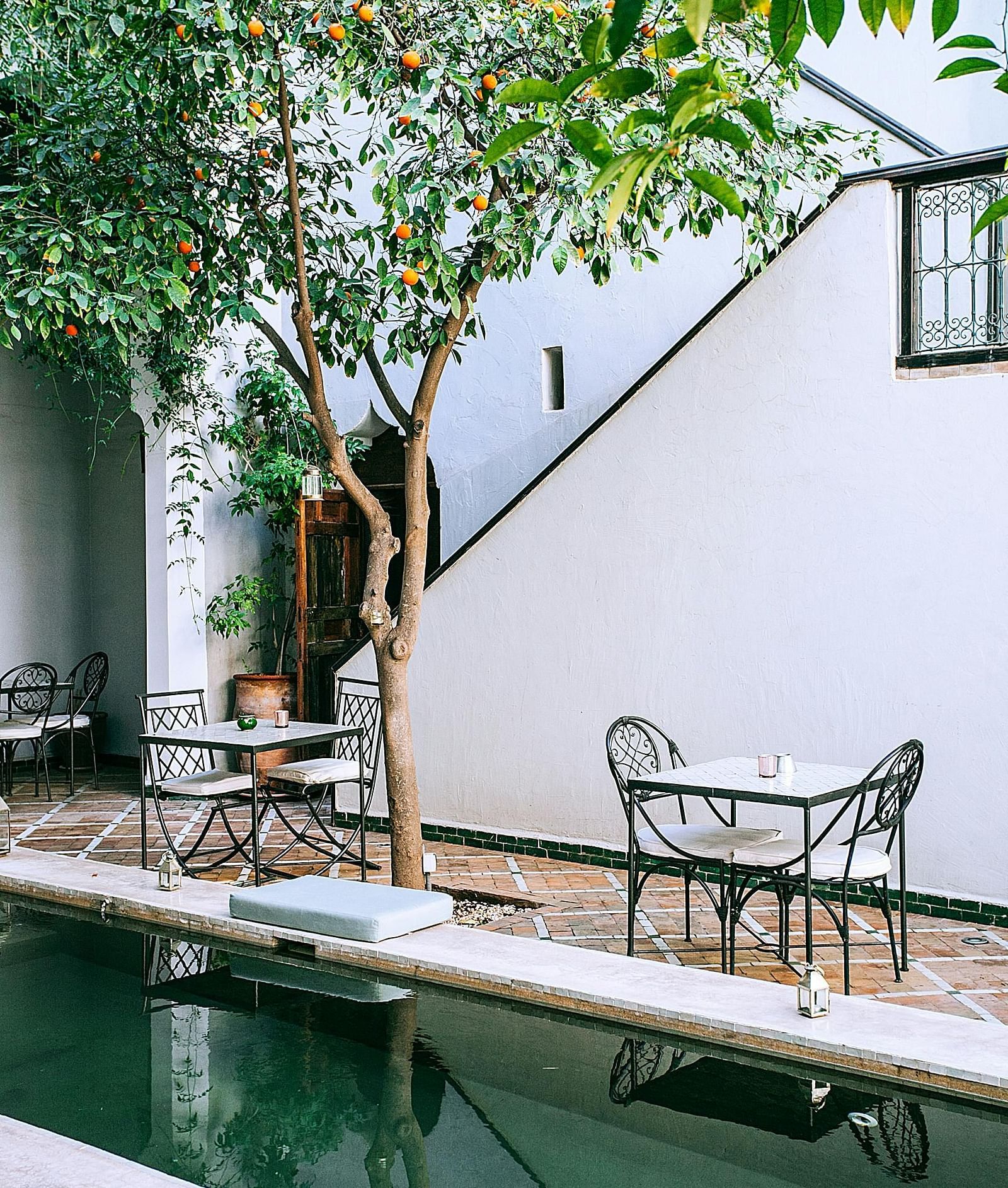 A plunge pool inside a hotel with seating arrangement besides it