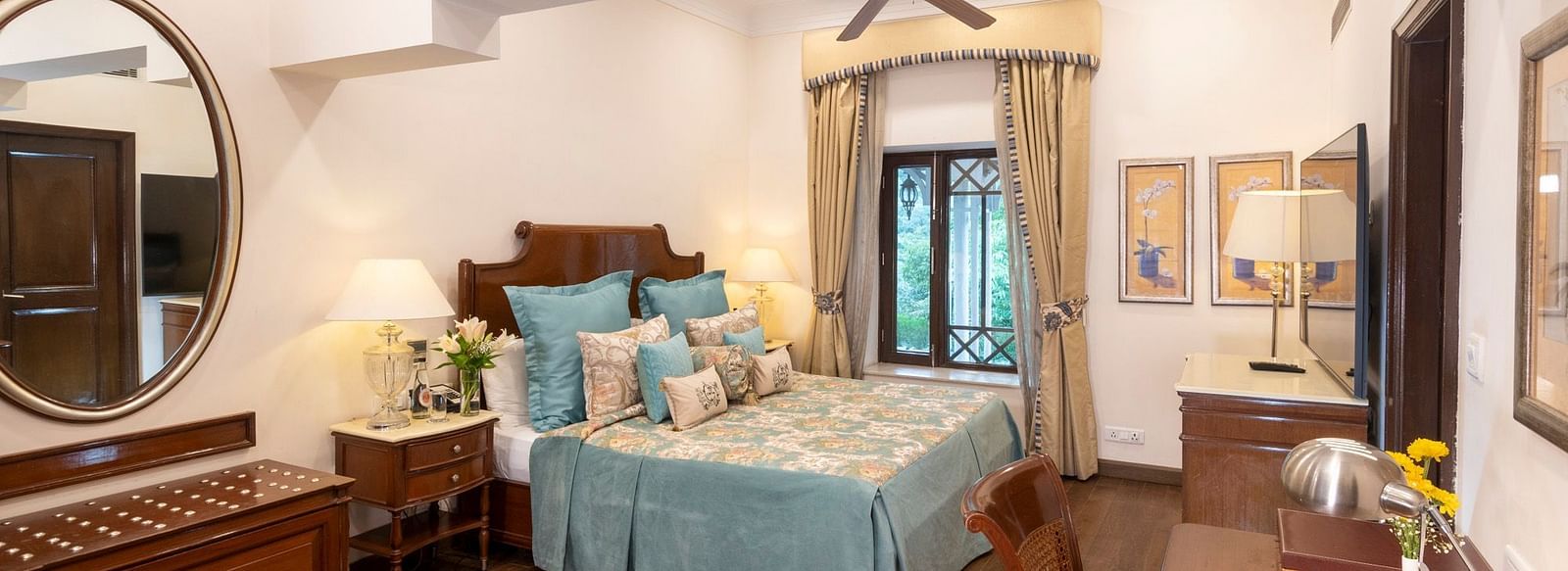view of the deluxe room with king sized bed and a mirror and a workspace at the Claridges Nabha Residence, Mussoorie