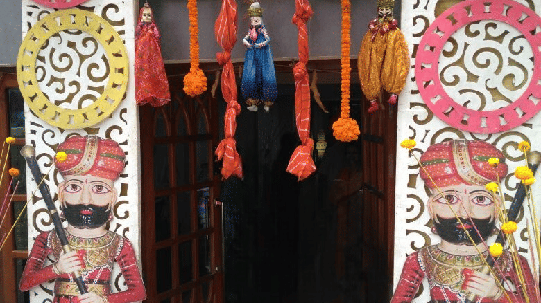 Vibrant and colourful entrance décor with traditional umbrellas and floral designs at Central Courtyard Boutique Hotel.