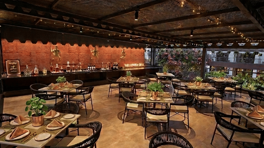 Raas Restobar's open-air seating area with set tables at night at BluSalzz Collection - Casa Onze, Arpora.