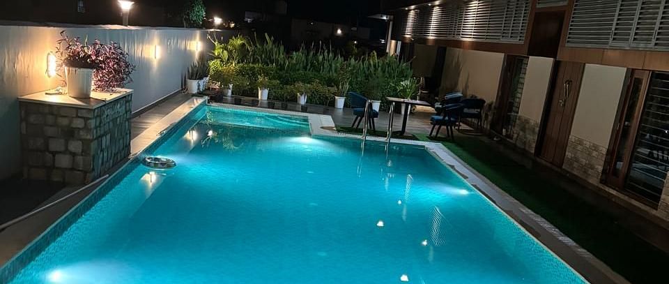 image of the swimming pool taken during the night at Eminence The Corbett