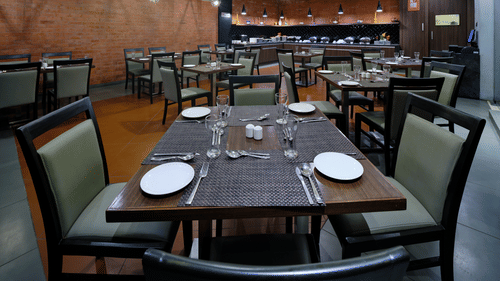 Pride Biznotel Manjusar - restaurant at our hotel with wooden floor and aesthetic interior2
