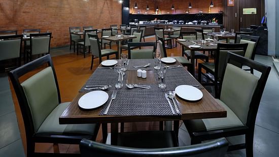 Pride Biznotel Manjusar - restaurant at our hotel with wooden floor and aesthetic interior2