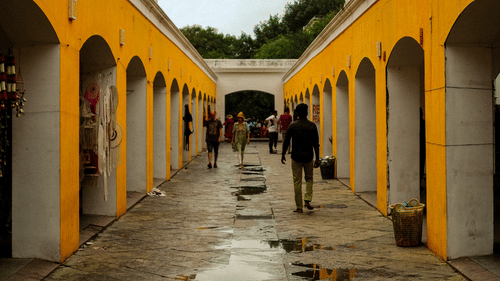 Guests walk along an arched corridor in a heritage market