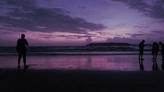 People on a beach after sundown