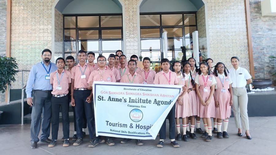 A group of people posing for a picture with a banner 
