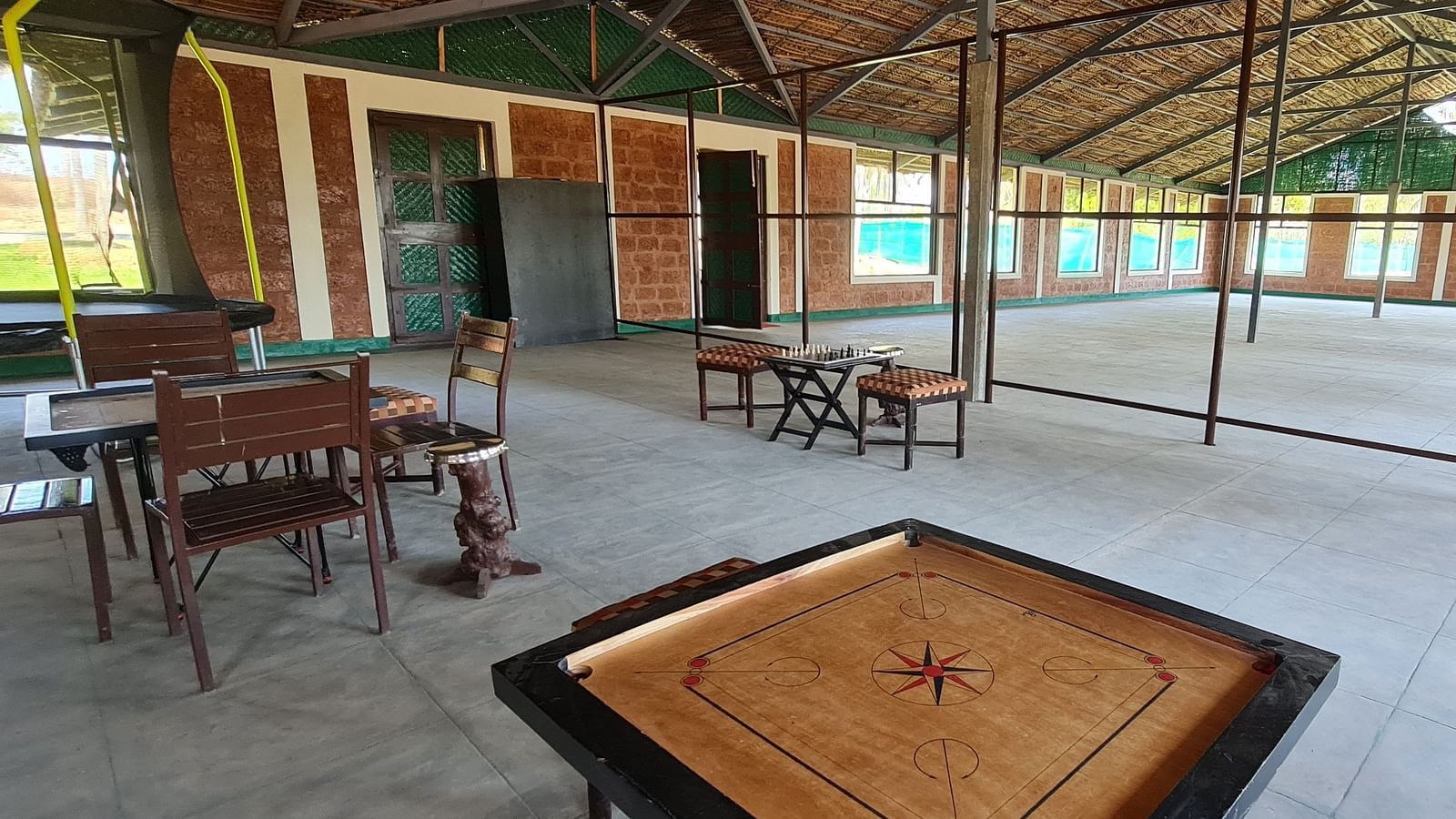 image of the activity area featuring a carom board at hoysala village resort in hassan