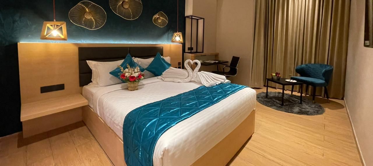 Double bed with blue sheets at Premium Room at Le Foliage by TGI, Bangalore