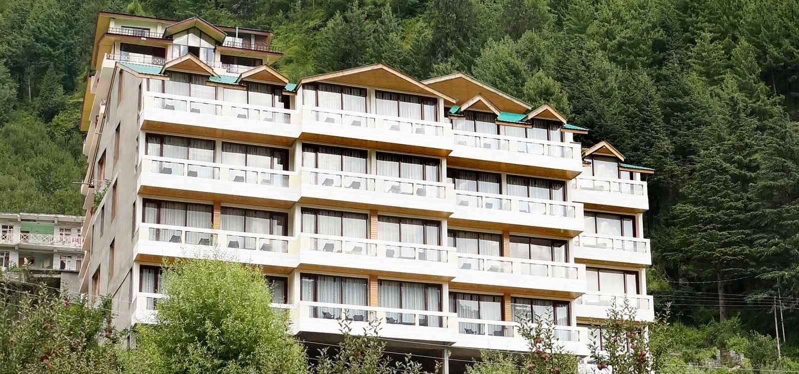 A wide angle shot of the hotel with greenery around  | DLS Serenity Resort and Spa