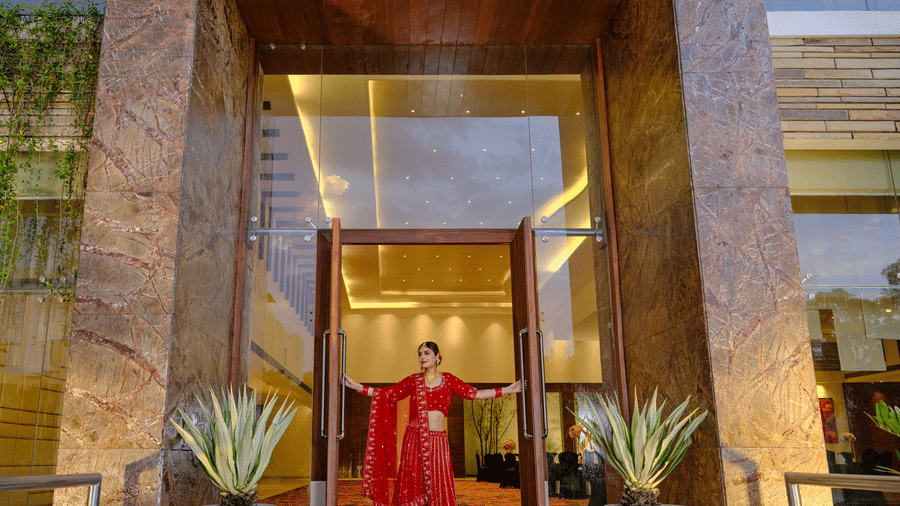 Shot of a lady in bridal  attire waiting at the gate of the hall | Best Western Country Woods Hotels and Resorts